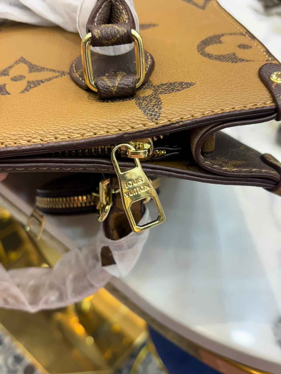 Louis Vuitton Lv on the go tote with coin pouch