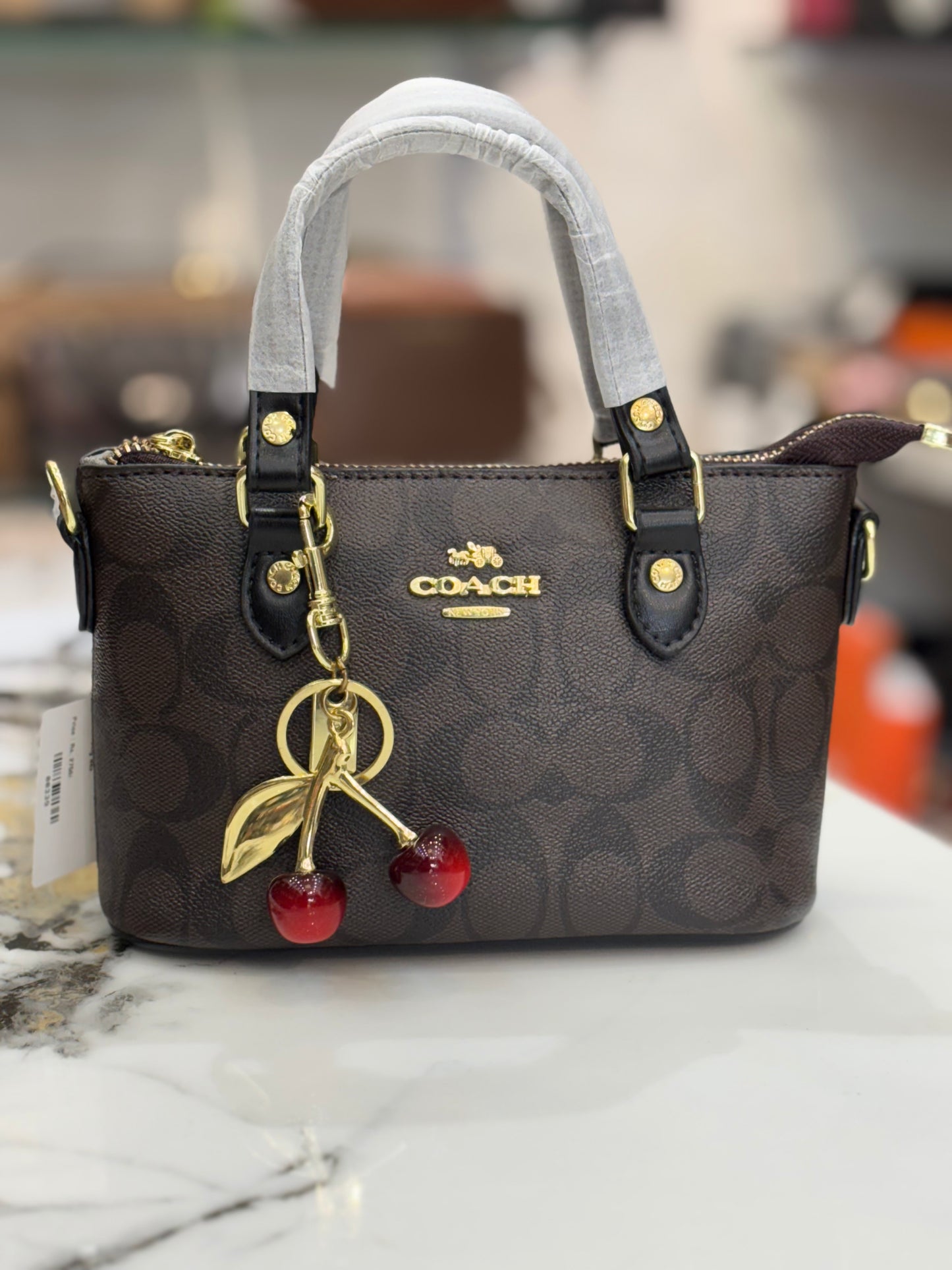 Coach mini crossbody bag with cherry charm
