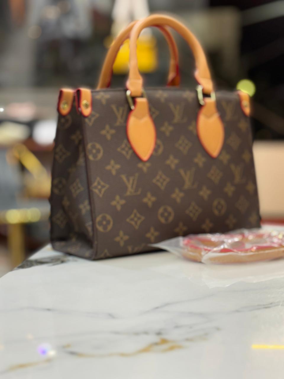Louis Vuitton (Lv)on the go tote with coin pouch for women