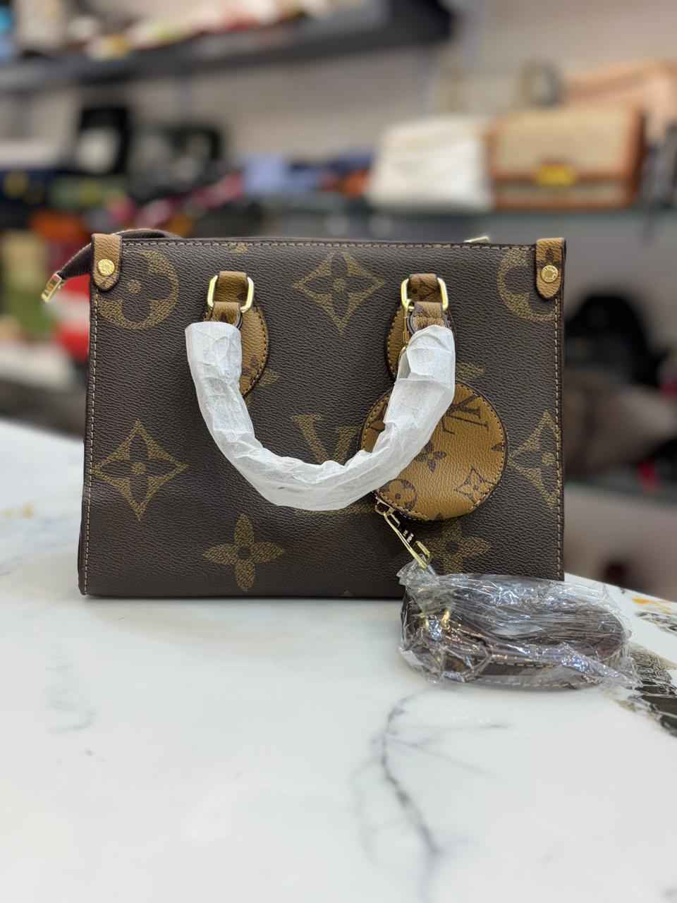 Louis Vuitton Lv on the go tote with coin pouch