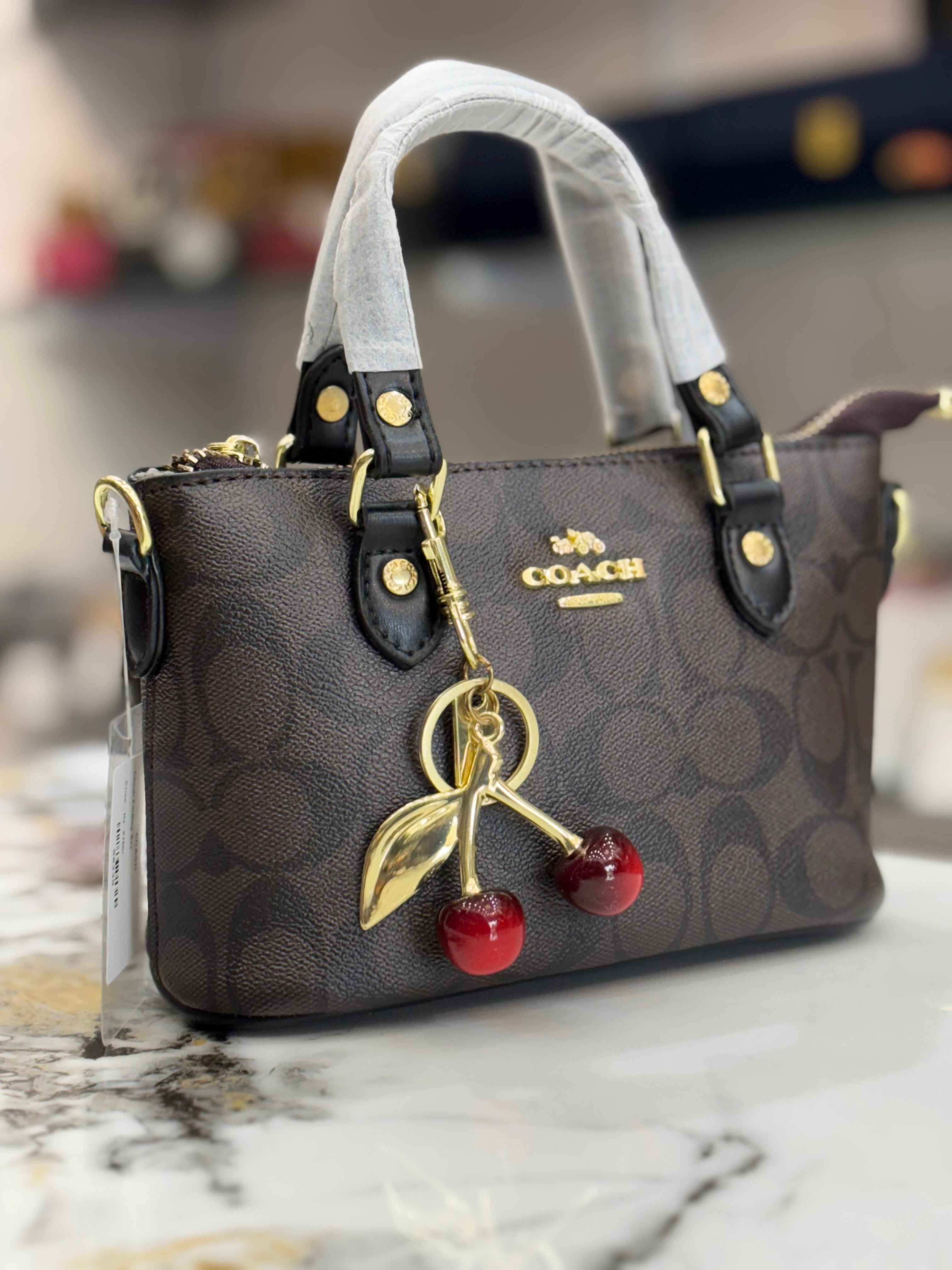Coach mini crossbody bag with cherry charm